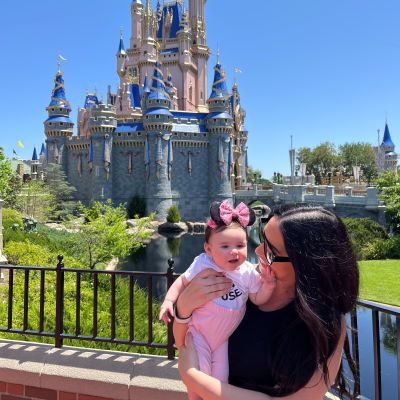 Enjoying the view of Cinderella Castle decked out for Walt Disney World's 50th Anniversary with my little one